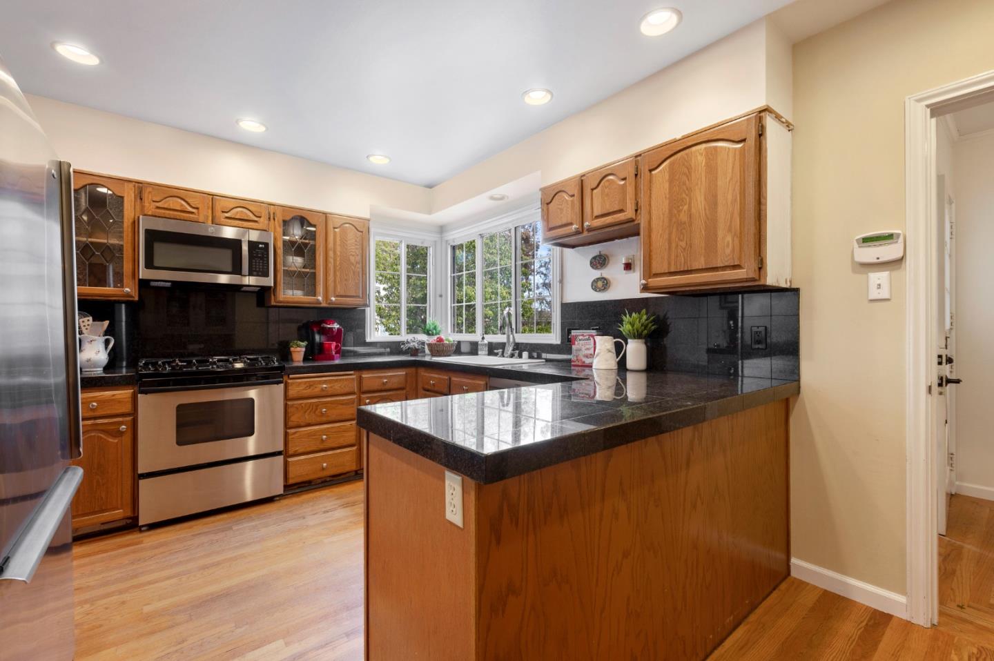 114 Arrowood Lane San Mateo, CA 94403 - Photo 12 of 28 a kitchen with stainless steel appliances granite countertop a sink a stove and a refrigerator
