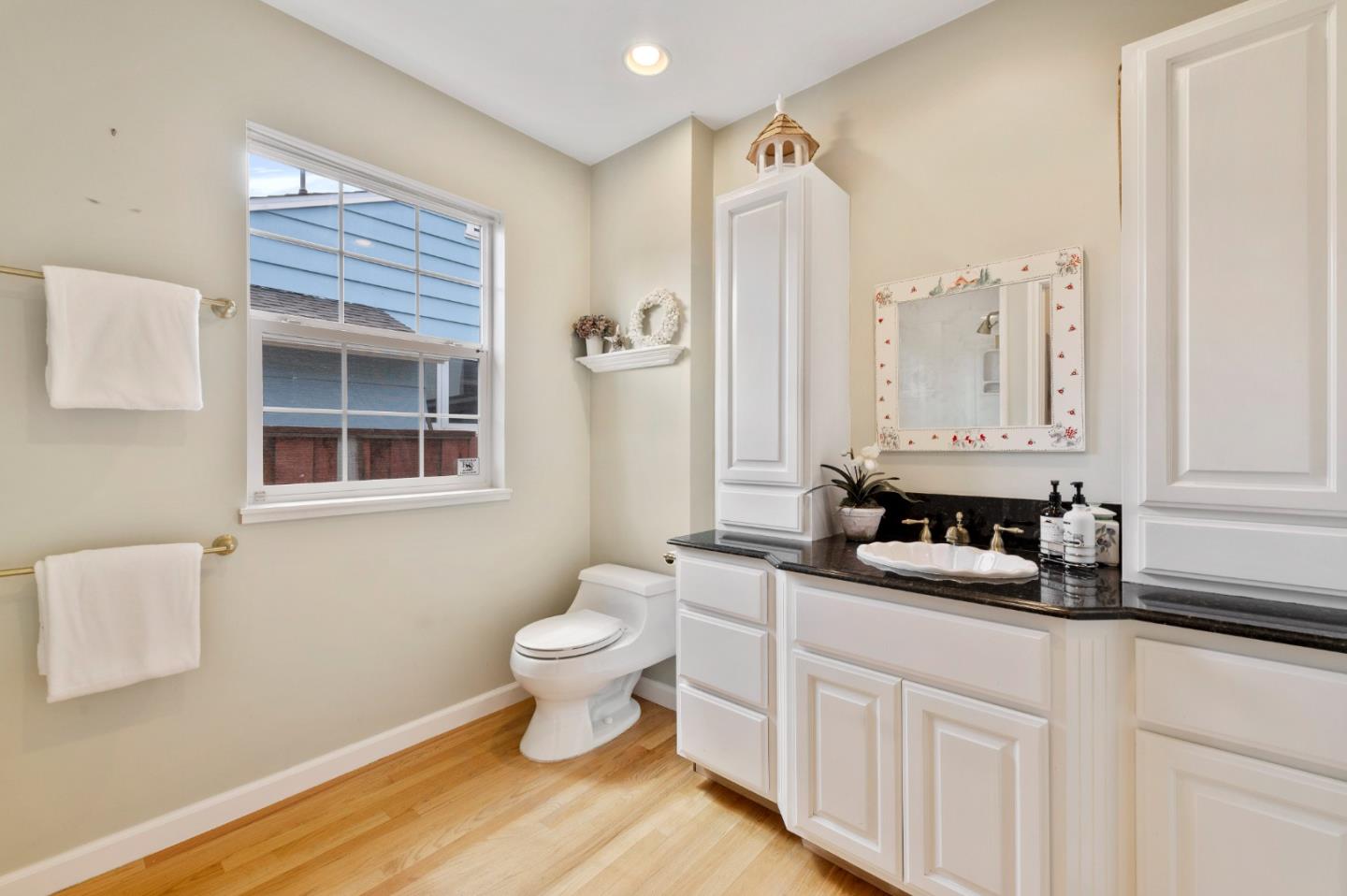 114 Arrowood Lane San Mateo, CA 94403 - Photo 15 of 28 a bathroom with a toilet a sink and a mirror
