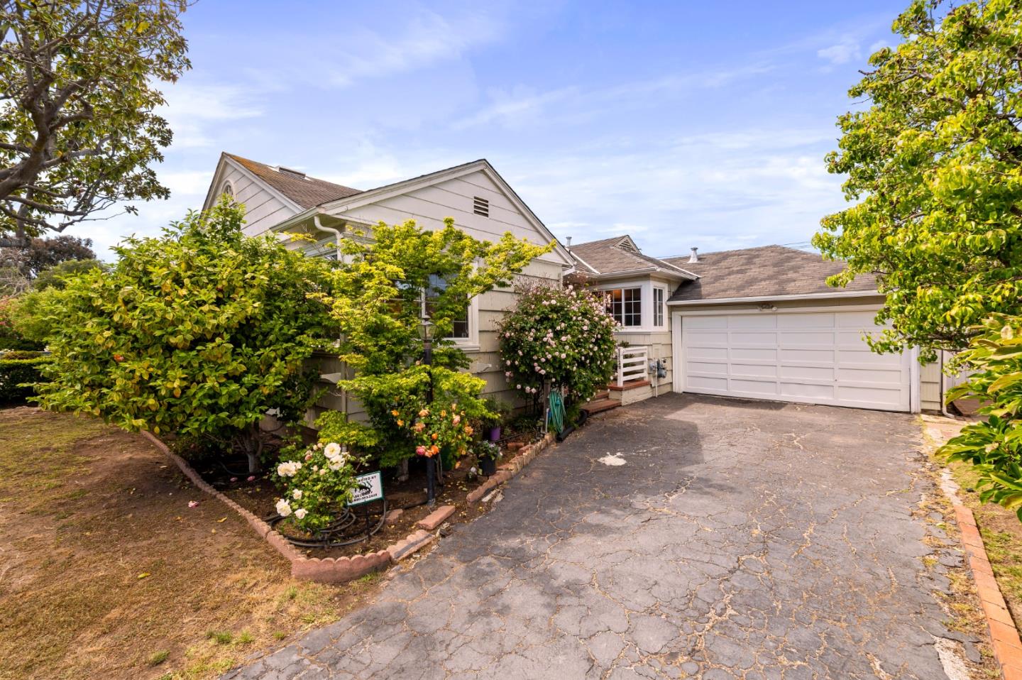 114 Arrowood Lane San Mateo, CA 94403 - Photo 2 of 28 a front view of a house with a yard and garage