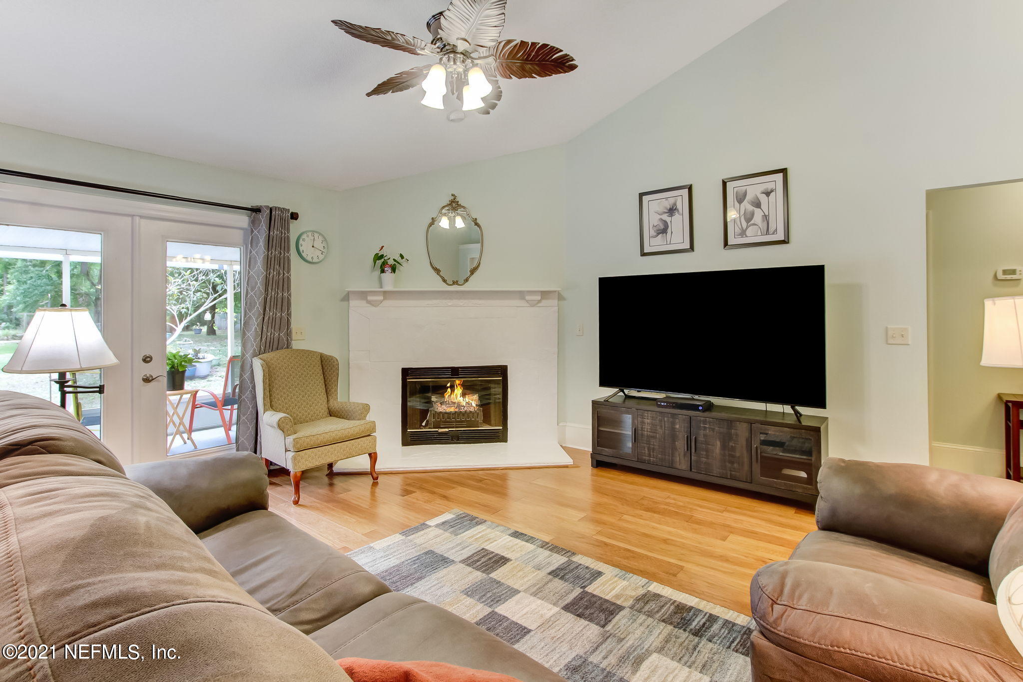 96450 Chester Road Yulee, FL 32097 - Photo 8 of 29 a living room with furniture a flat screen tv and a fireplace