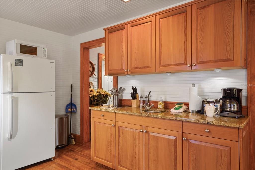 702 Pass A Grille Way St. Pete Beach, FL 33706 - Photo 30 of 41 a kitchen with stainless steel appliances granite countertop a refrigerator and a sink
