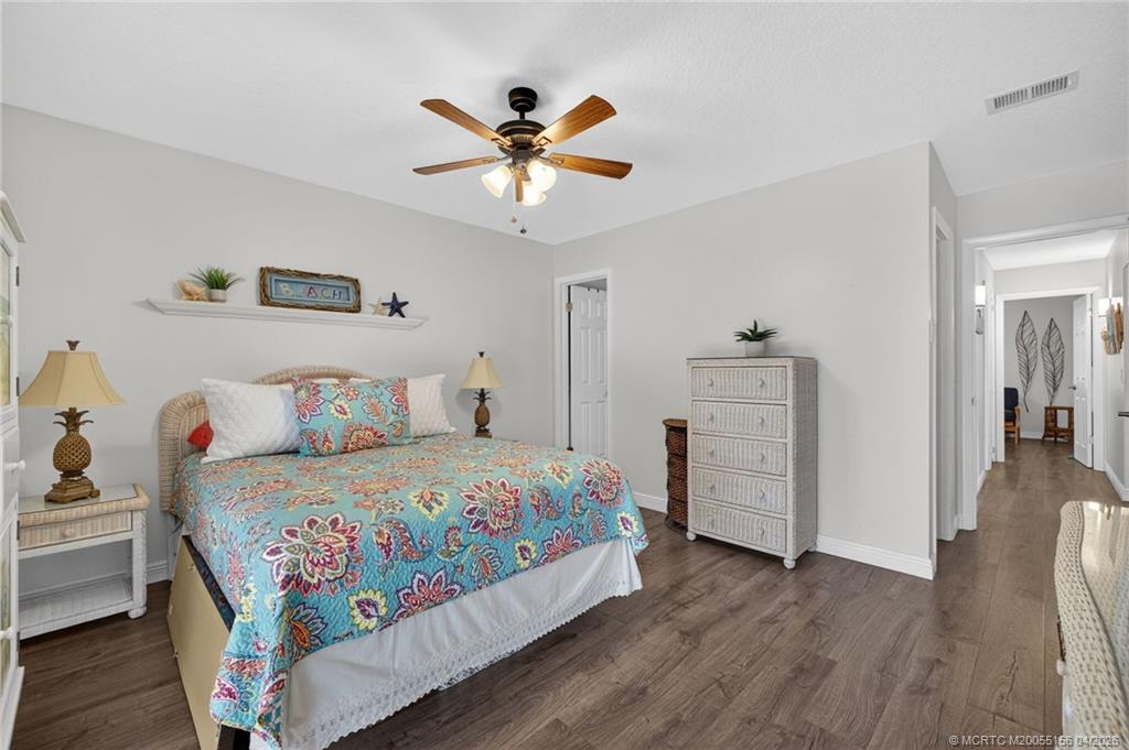 1225 Northwest 21st Street, Unit 2615 Stuart, FL 34994 - Photo 14 of 43 Primary en suite bedroom updated flooring and lighting.