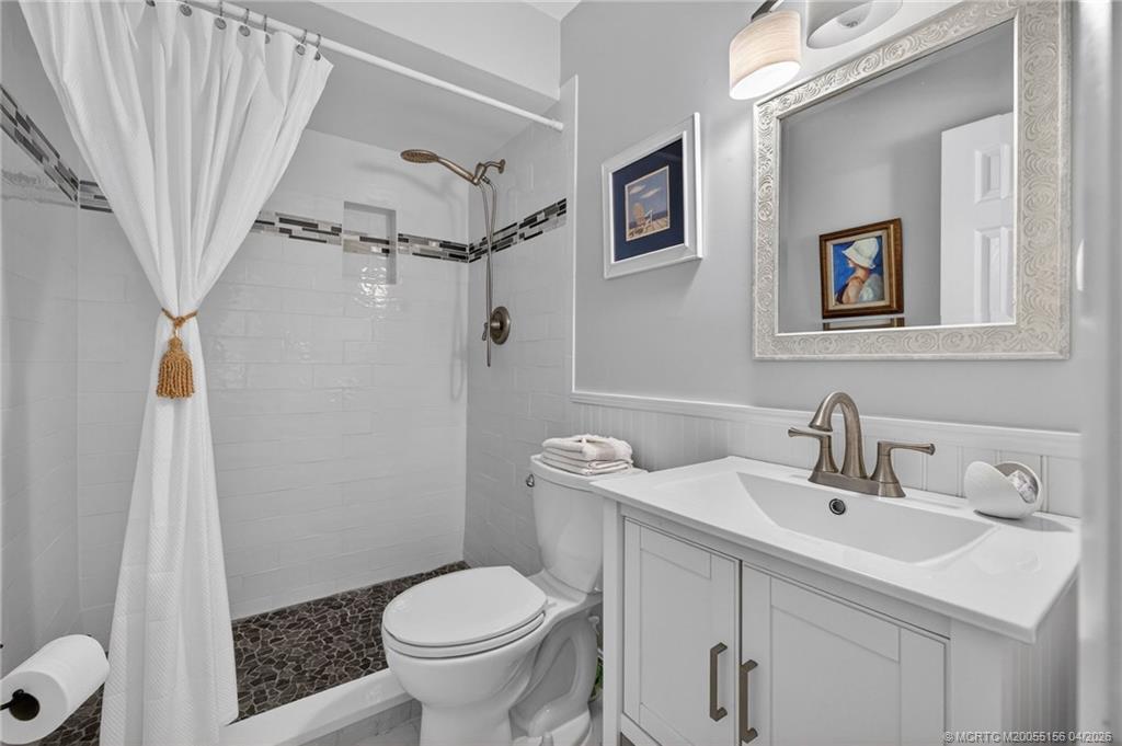 1225 Northwest 21st Street, Unit 2615 Stuart, FL 34994 - Photo 16 of 43 Updated en suite bathroom with beautiful tile work in the walk in shower.