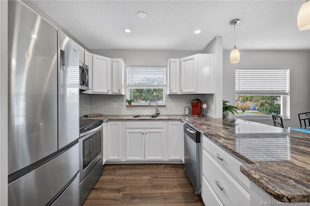 1225 Northwest 21st Street, Unit 2615 Stuart, FL 34994 - Photo 2 of 43 Granite countertops paired with stainless. appliances.