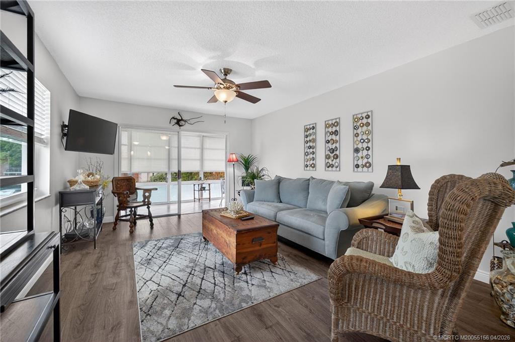 1225 Northwest 21st Street, Unit 2615 Stuart, FL 34994 - Photo 7 of 43 Living area opens to the enclosed lanai.