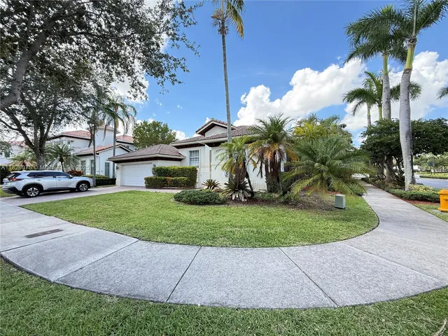 a view of a house with a yard and a garden