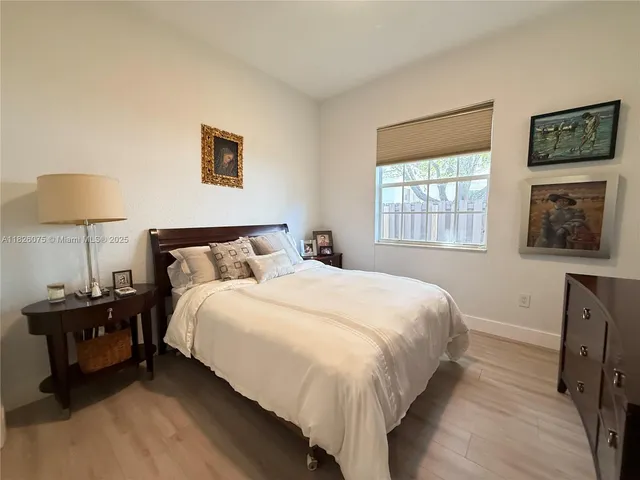 a bedroom with a bed and a lamp