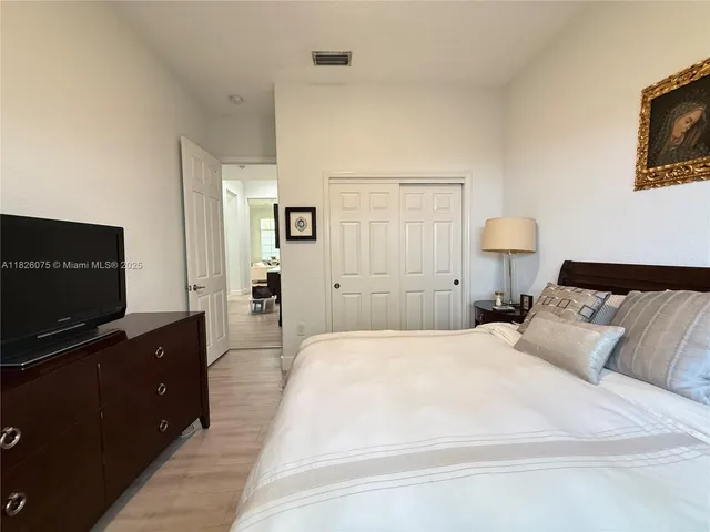 a bedroom with a bed and a flat screen tv