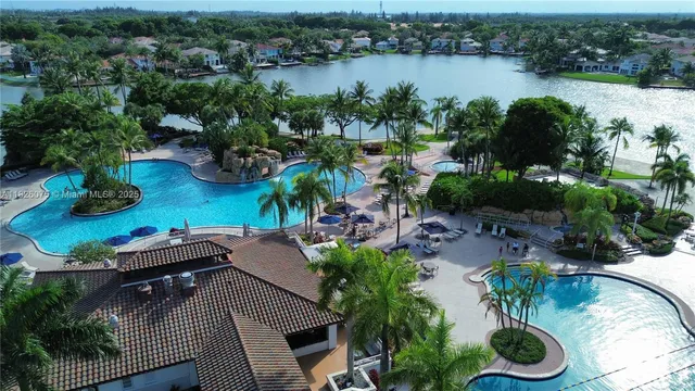 an aerial view of a house with outdoor space and lake view