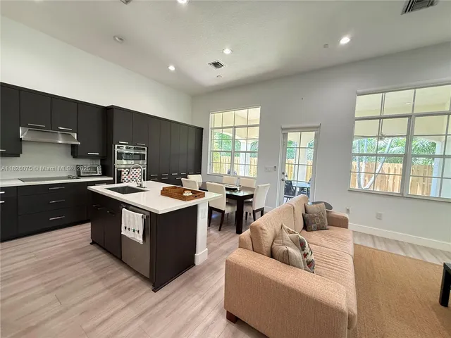 a kitchen with a stove and a refrigerator
