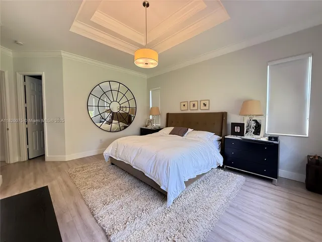 a bedroom with a bed and a chandelier