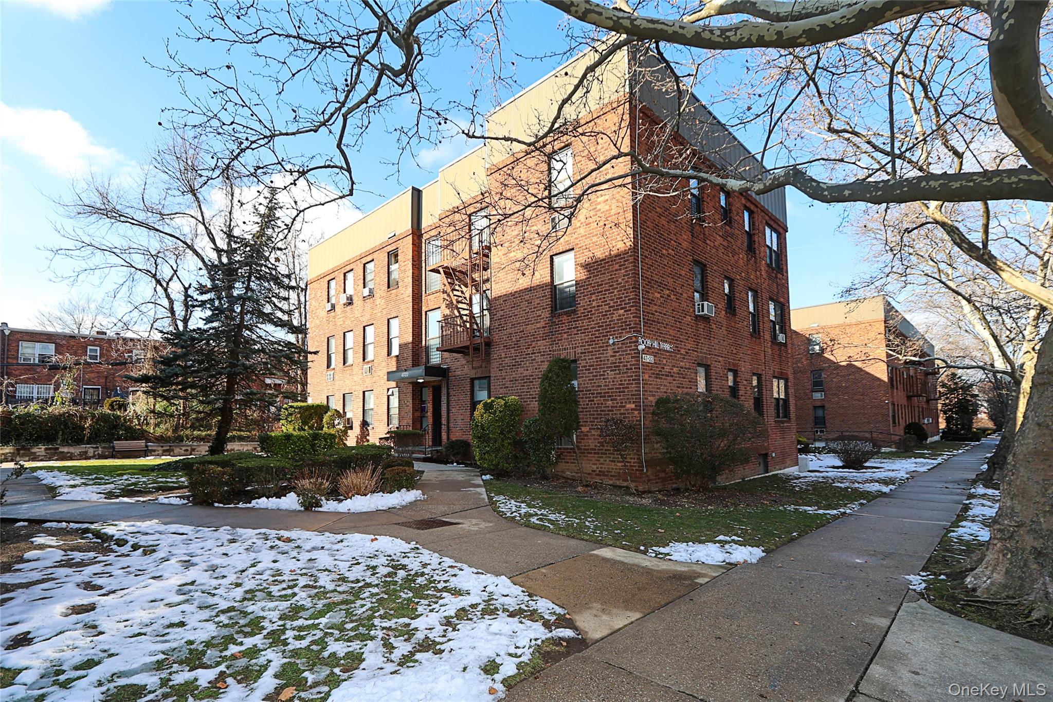 View of snowy exterior with brick siding