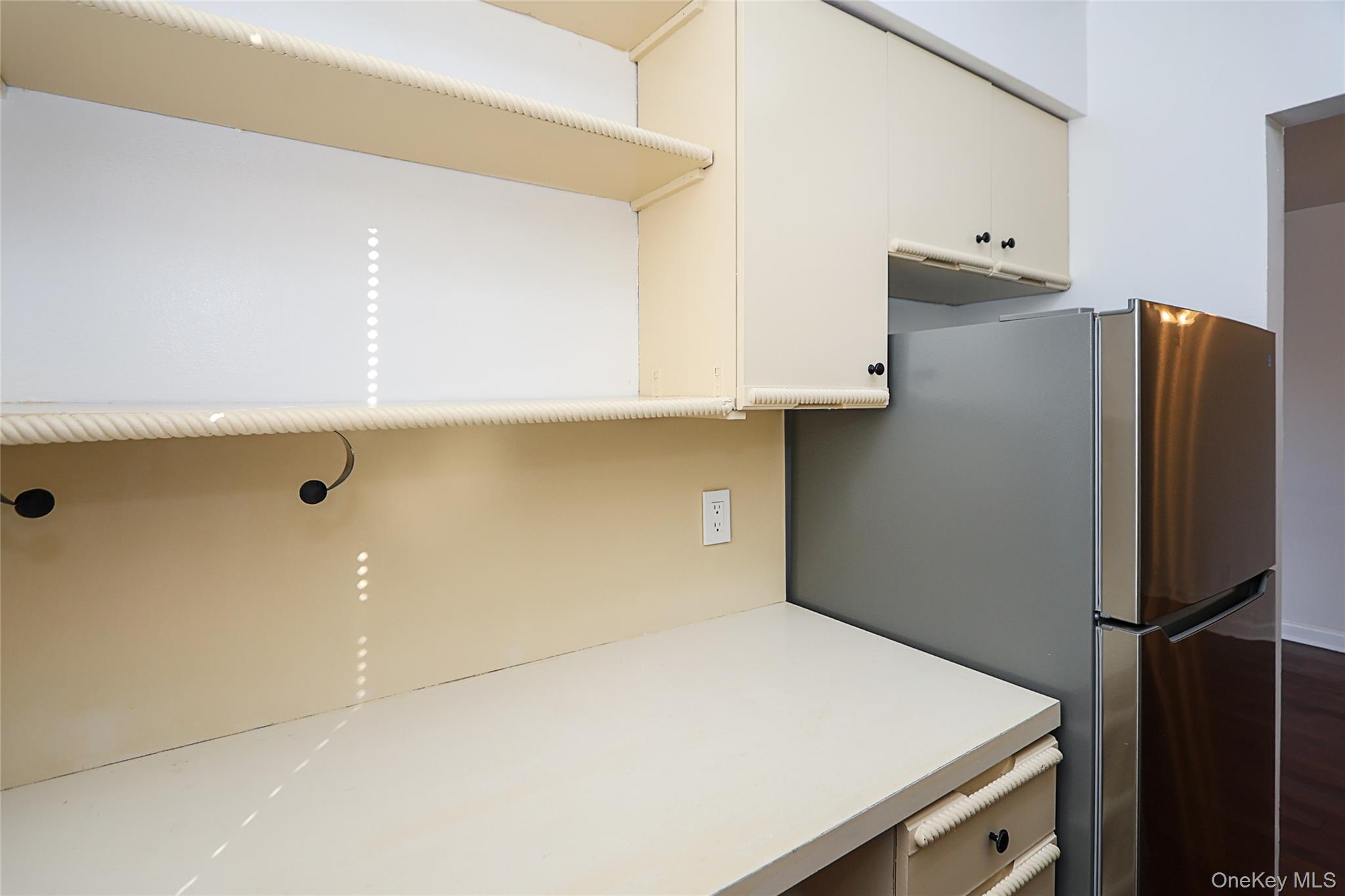 47-22 215th Place, Unit 2C Queens, NY 11361 - Photo 17 of 26 Kitchen with light countertops and freestanding refrigerator