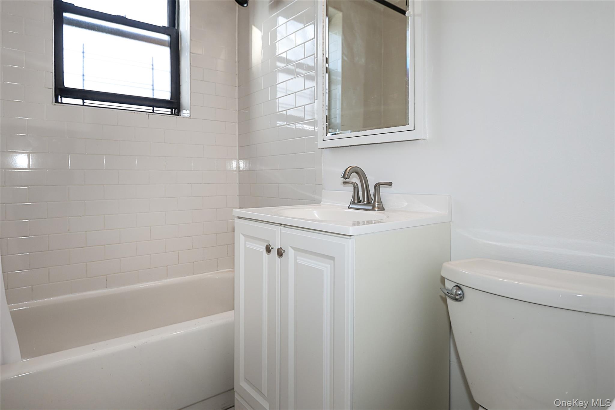 47-22 215th Place, Unit 2C Queens, NY 11361 - Photo 22 of 26 Bathroom featuring vanity and shower / bathtub combination