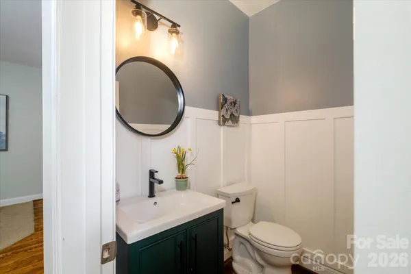 a bathroom with a toilet a sink and a mirror