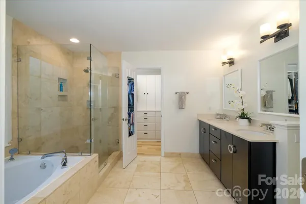 a spacious bathroom with a shower sink and mirror