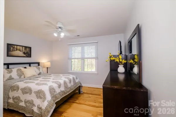 a bedroom with a bed and ceiling fan