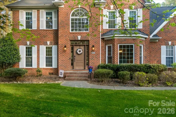 a view of a brick building next to a yard
