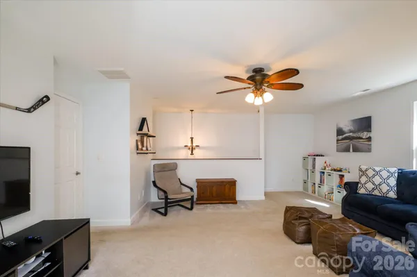 a workspace with furniture and a ceiling fan