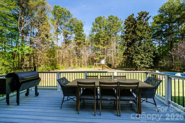 a view of a chairs and table on the deck