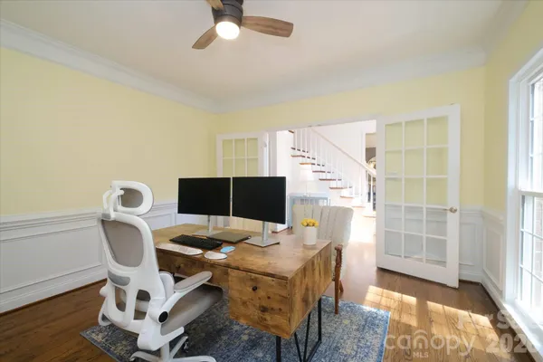 a view of a workspace with furniture and a window