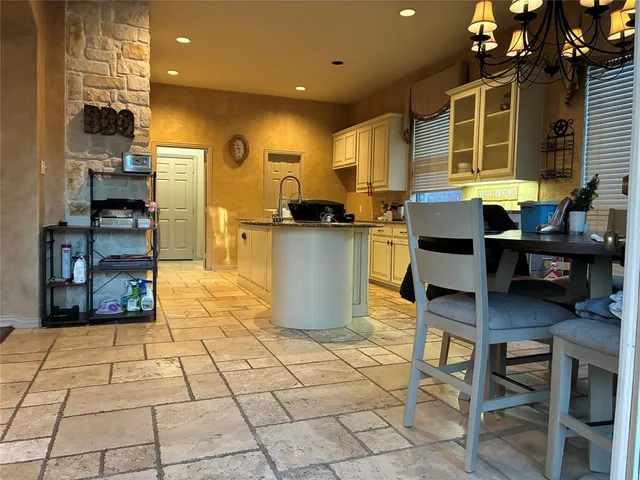 a kitchen with a table and chairs in it