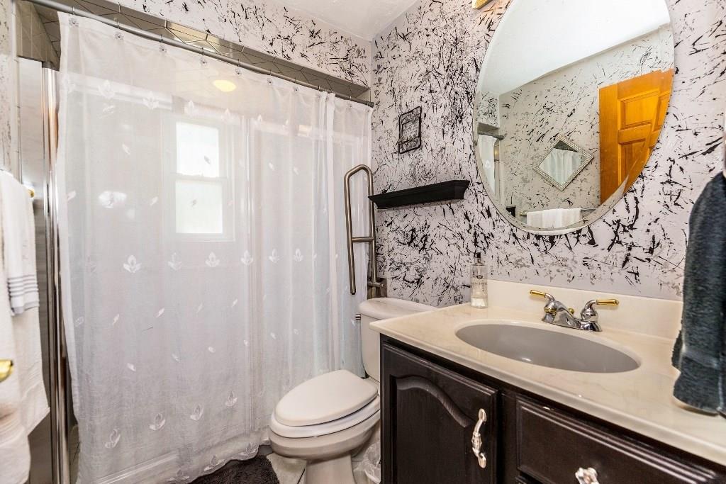 422 Thompsonville Road McMurray, PA 15317 - Photo 13 of 25 Updated main floor bath provides walk-in shower, ceramic tile, vanity and solid surface counter and toilet.
