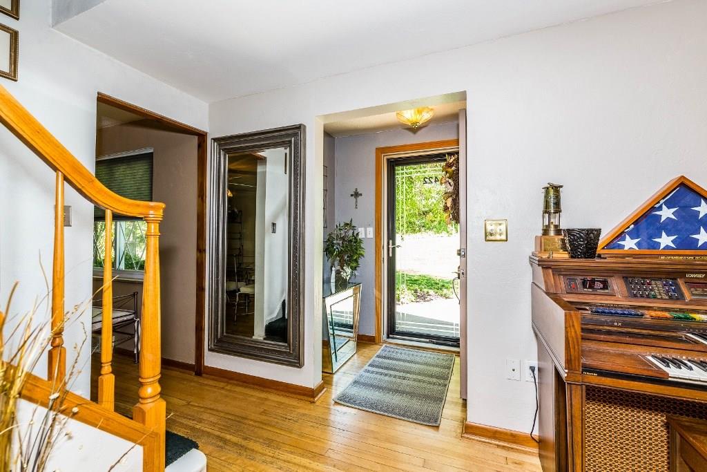 Inviting entrance with a coat closet.  Hardwood floors and neutral colors.