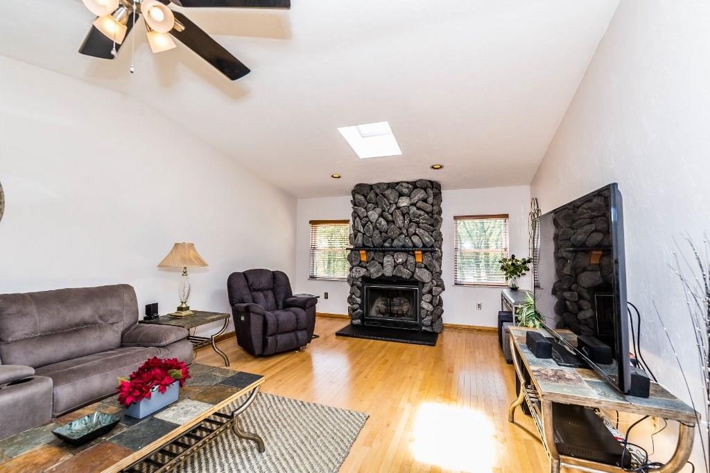 Enjoy chilly evening with the warmth of this gas fireplace which can also be converted to logs.  Hardwood floor and neutral colors, skylight and vaulted ceiling.