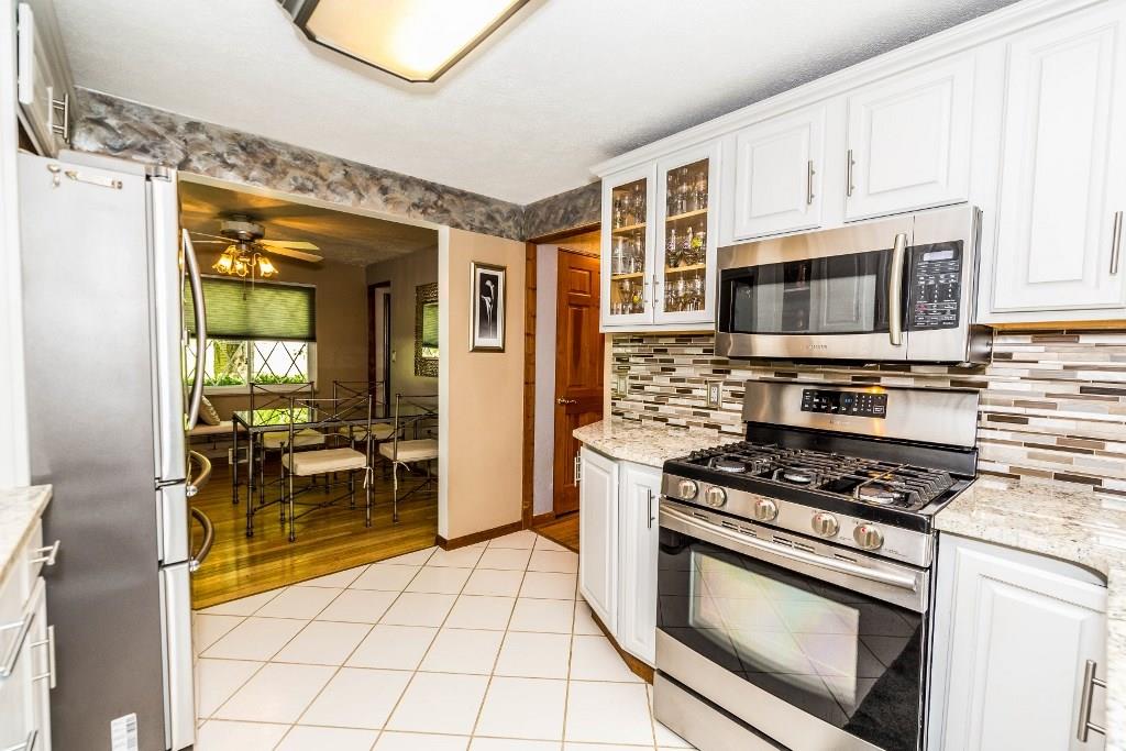 Beautifully updated kitchen with white cabinetry, Samsung Stainless Appliances.
