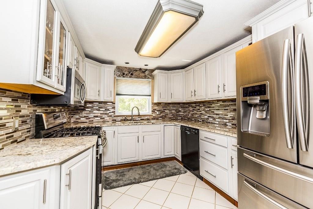 422 Thompsonville Road McMurray, PA 15317 - Photo 8 of 25 Granite countertops, tiled backsplash, ceramic floor and a window overlooking the gorgeous back yard.