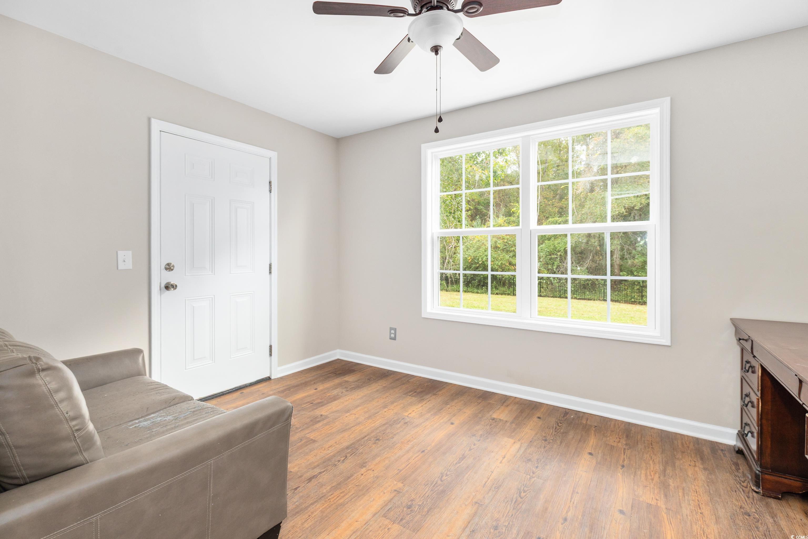 3106 Dog Bluff Road Aynor, SC 29511 - Photo 11 of 27 Unfurnished room featuring dark wood finished floors and a ceiling fan