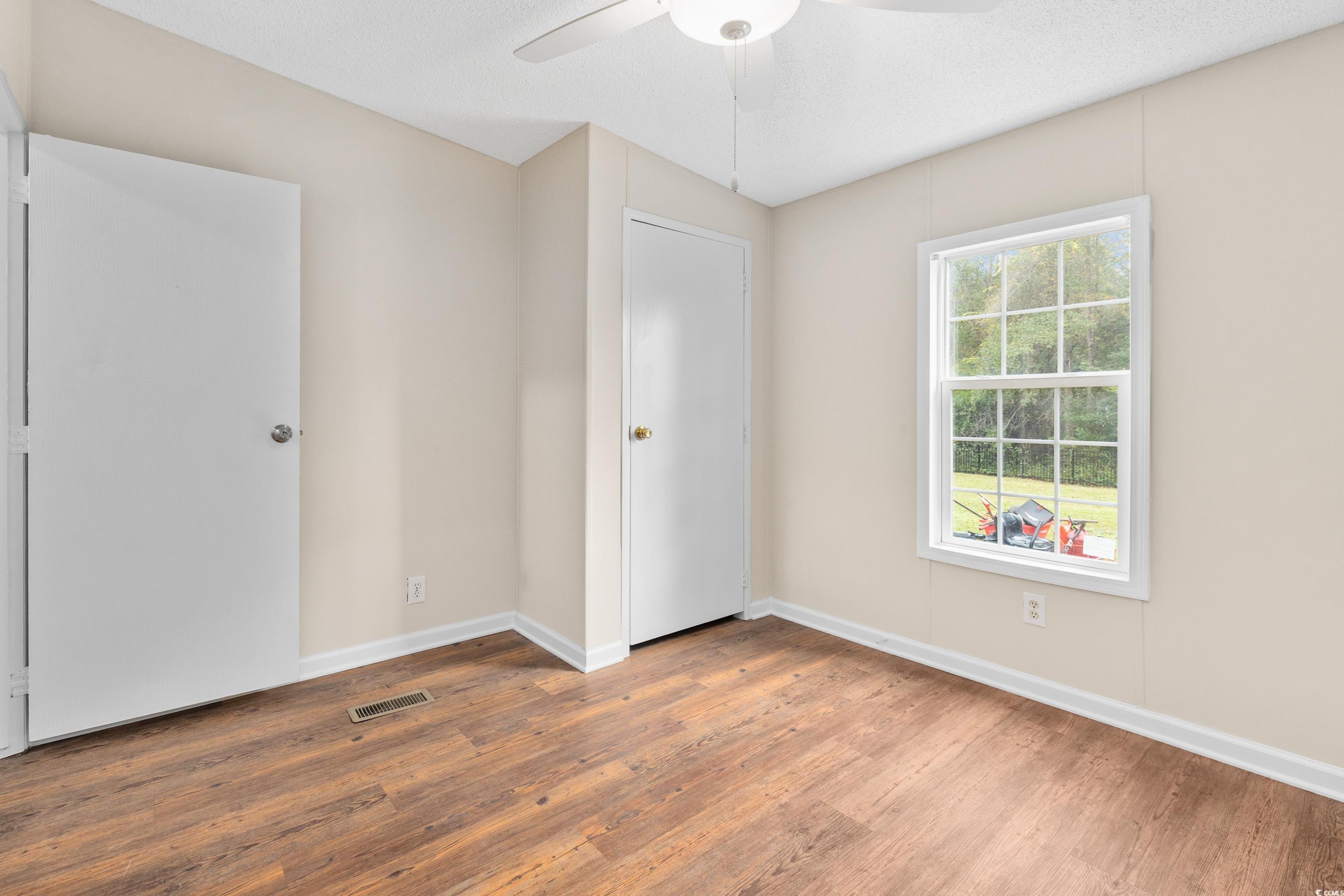 3106 Dog Bluff Road Aynor, SC 29511 - Photo 20 of 27 Unfurnished bedroom featuring wood finished floors and a ceiling fan