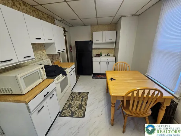 a kitchen with a sink appliances and cabinets
