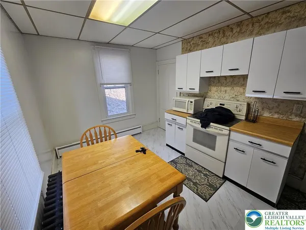 a kitchen with a sink a stove and cabinets