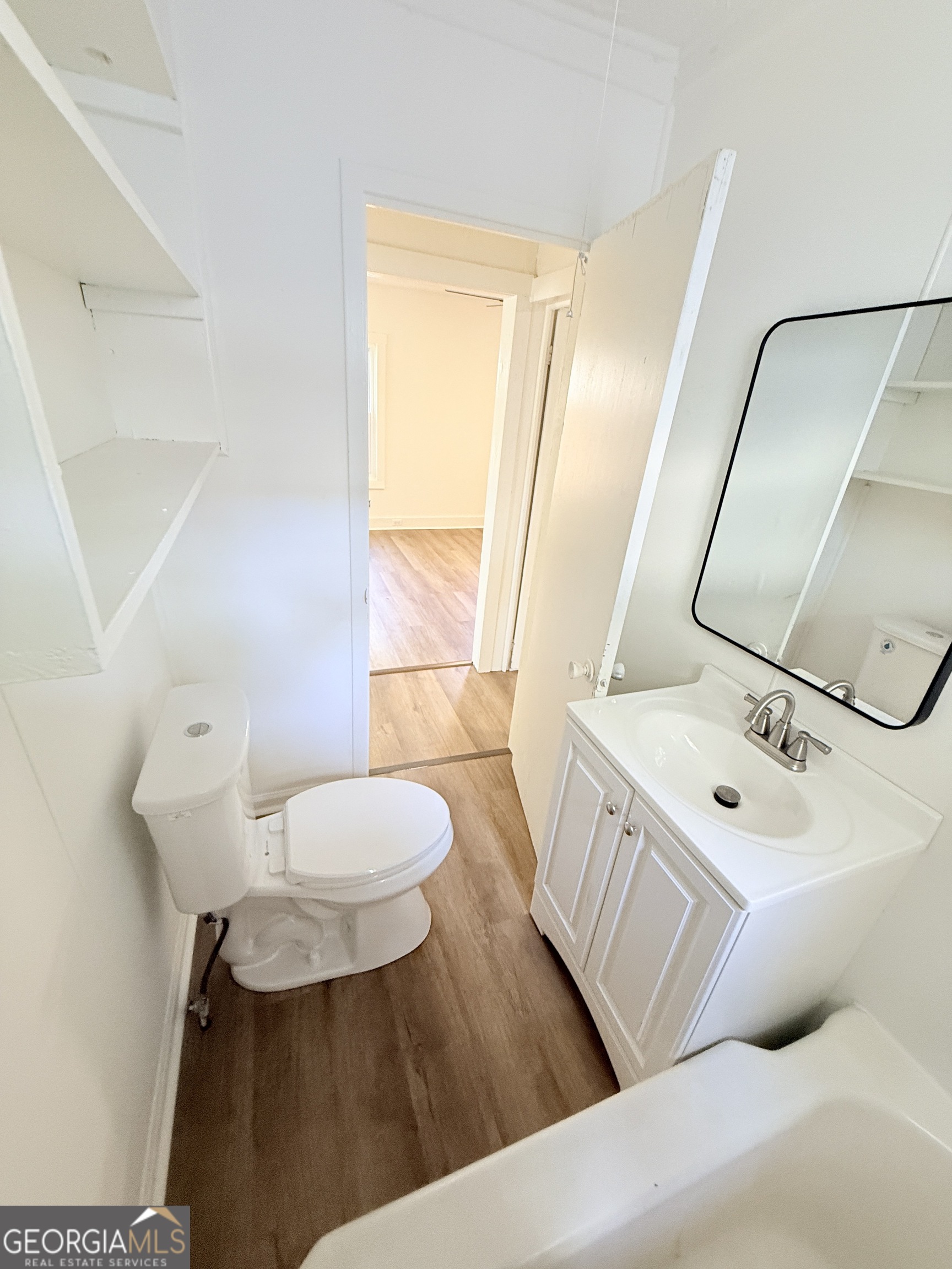 2416 Union Street Brunswick, GA 31520 - Photo 8 of 12 a bathroom with a sink mirror vanity and toilet