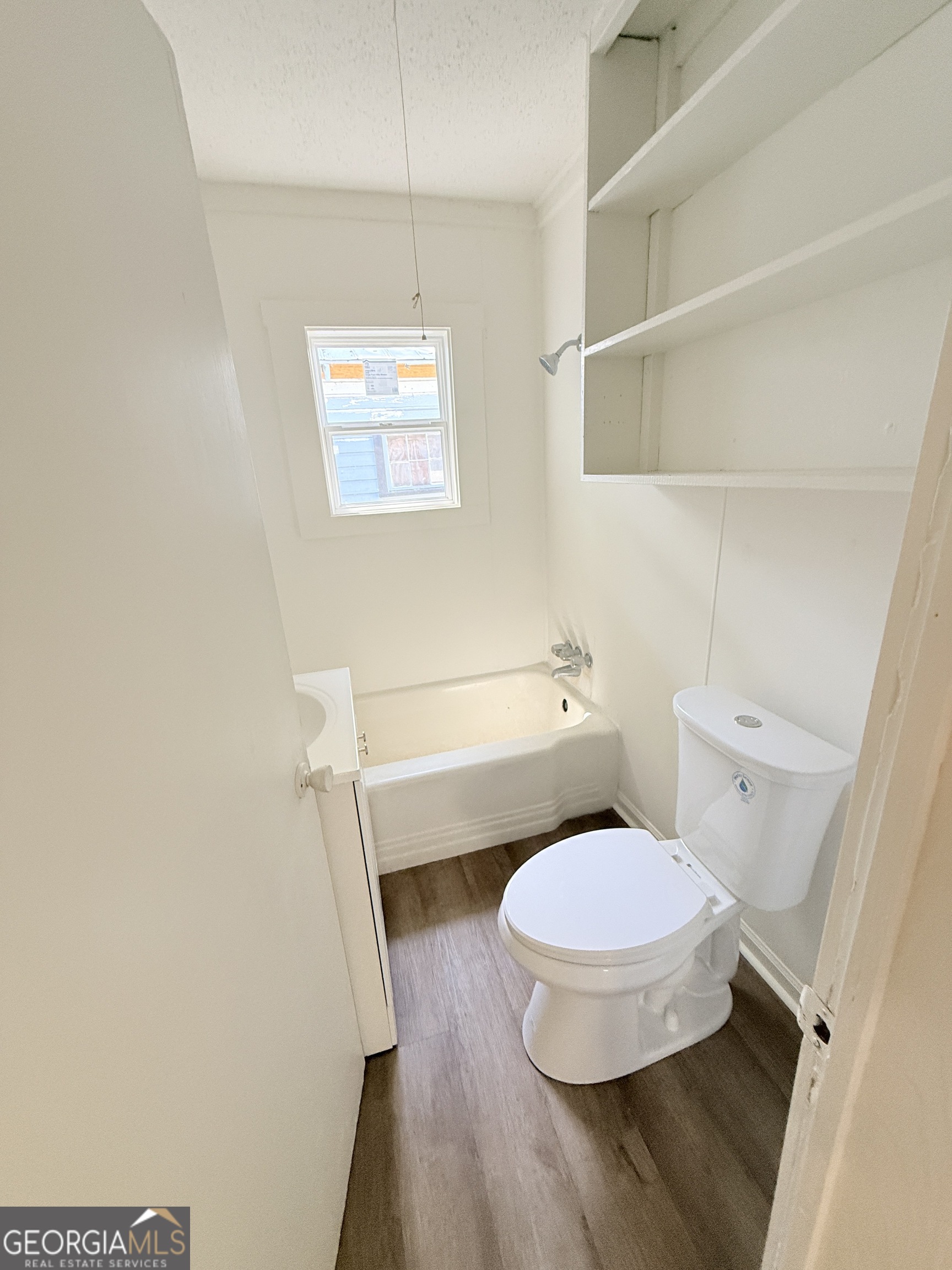 2416 Union Street Brunswick, GA 31520 - Photo 9 of 12 a bathroom with a toilet and a shower