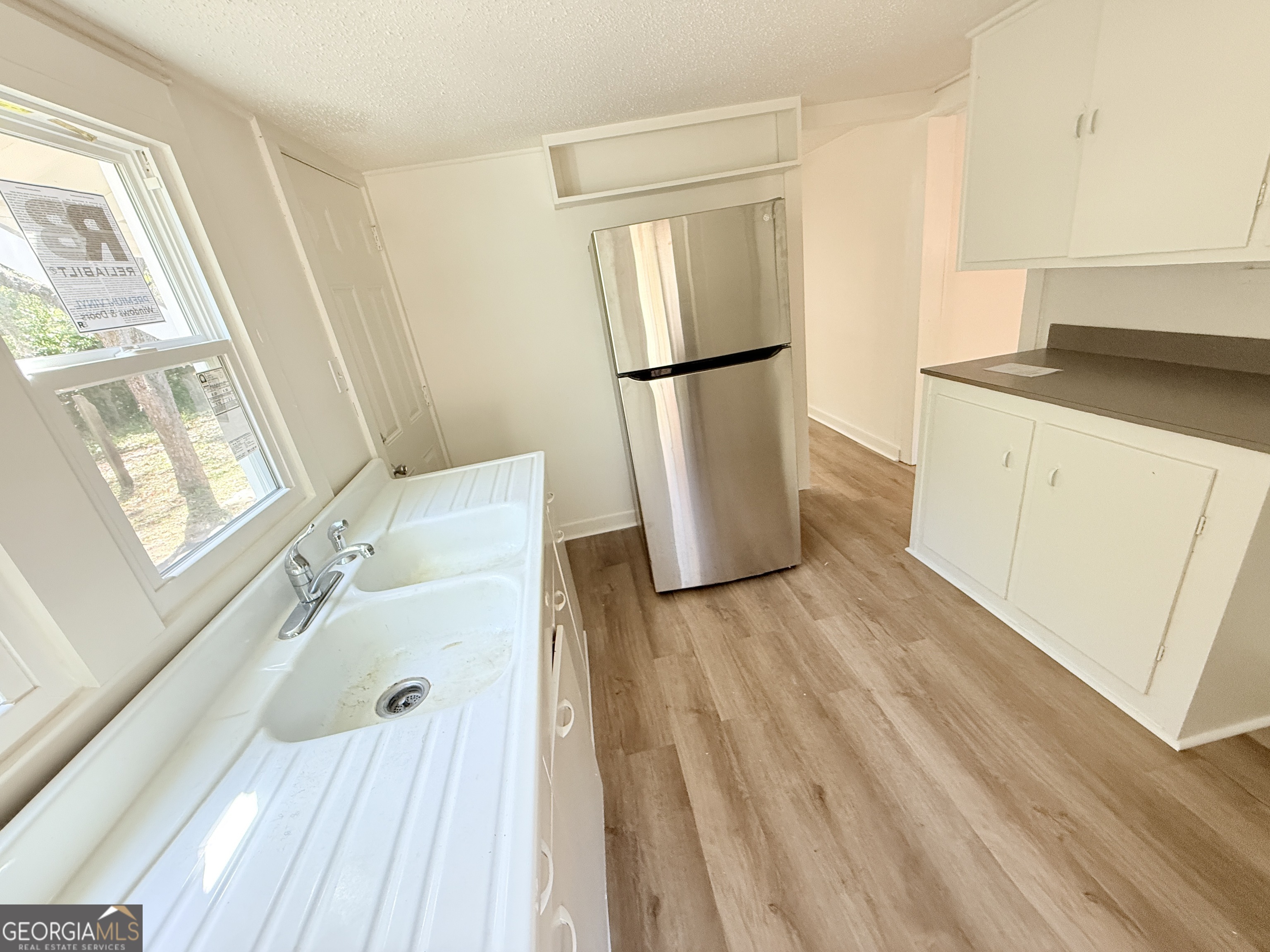 2416 Union Street Brunswick, GA 31520 - Photo 10 of 12 a walk in closet with wooden floor and a window
