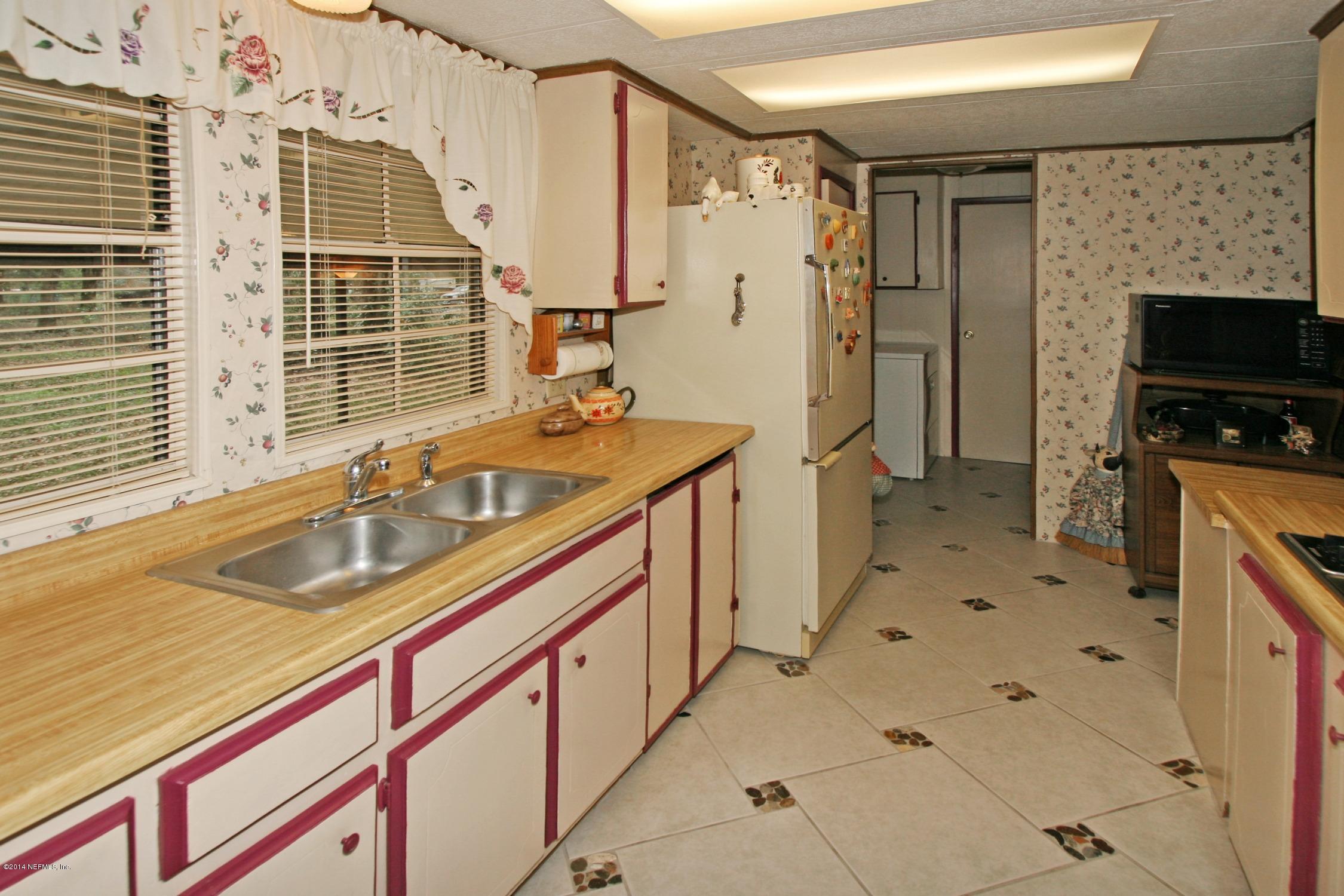 9894 Hood Road Jacksonville, FL 32257 - Photo 5 of 14 a bathroom with a sink a mirror and a shower