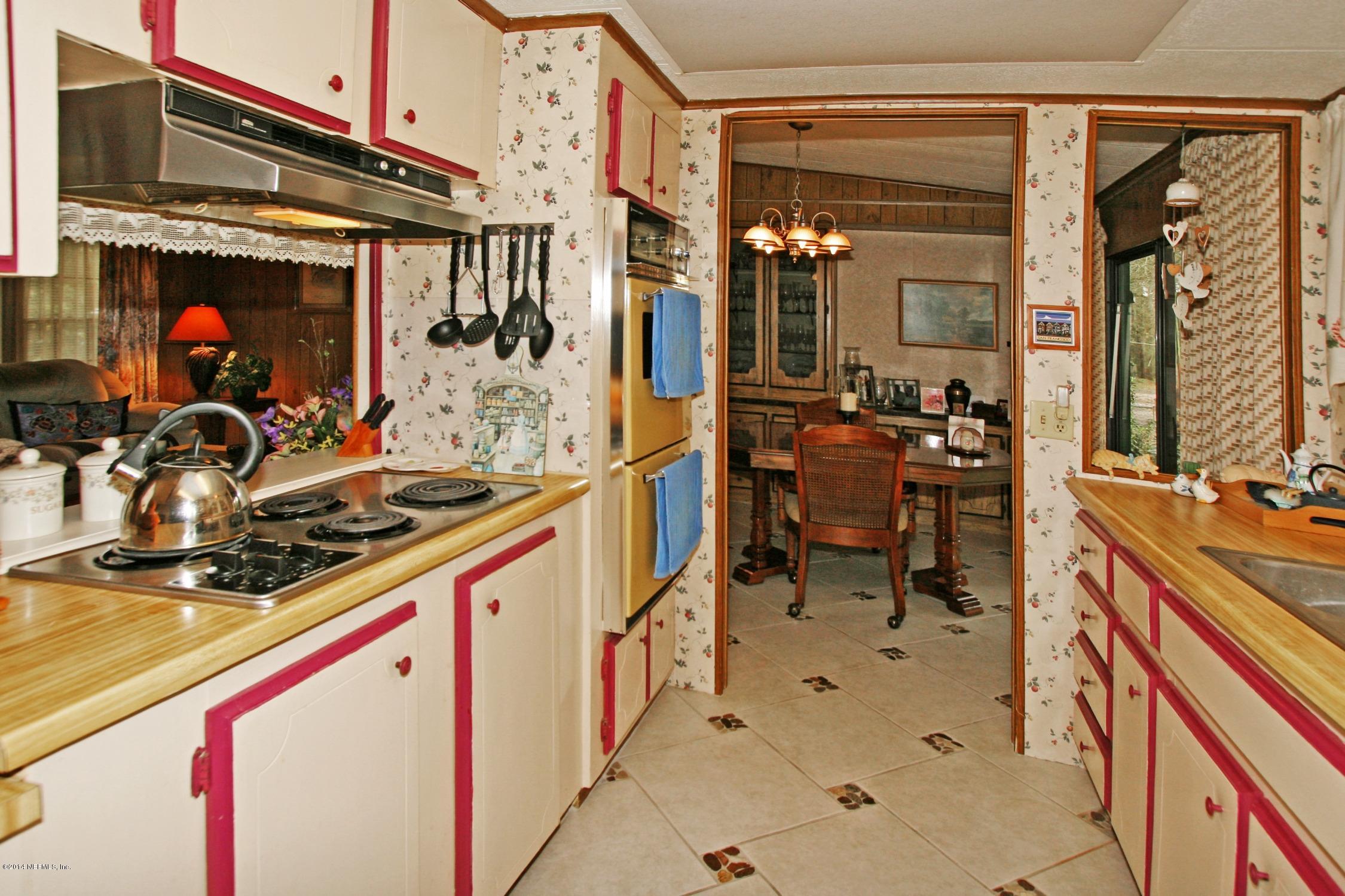 9894 Hood Road Jacksonville, FL 32257 - Photo 6 of 14 a kitchen with stainless steel appliances a sink and a stove