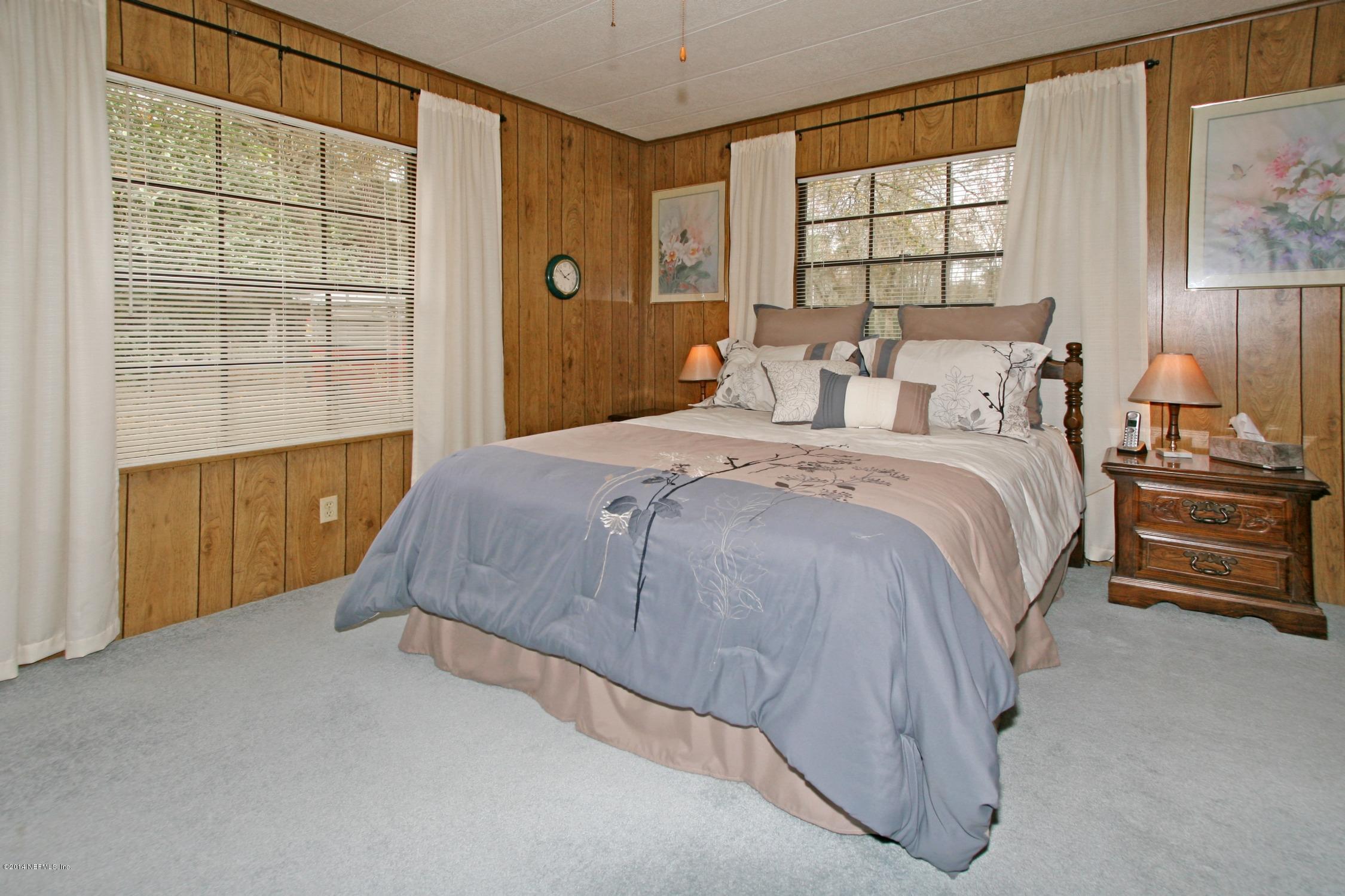 9894 Hood Road Jacksonville, FL 32257 - Photo 8 of 14 a bedroom with a bed and a window