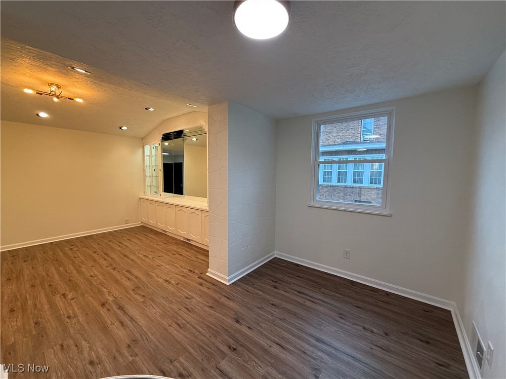 522 North 3rd Street Toronto, OH 43964 - Photo 15 of 47 Empty room featuring a textured ceiling and dark wood-type flooring