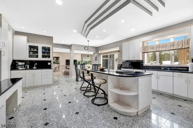 a bathroom with a granite countertop sink a toilet and a mirror