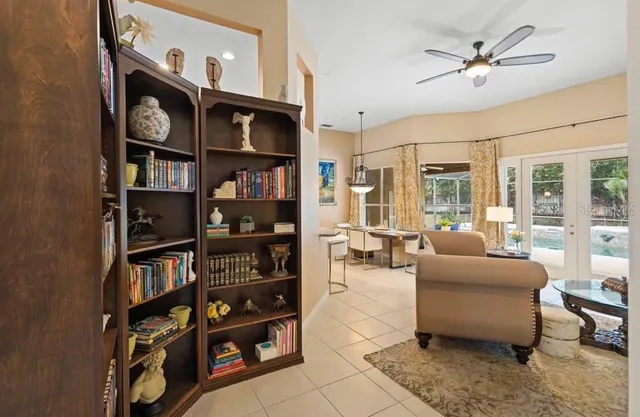 a living room with furniture and a book shelf