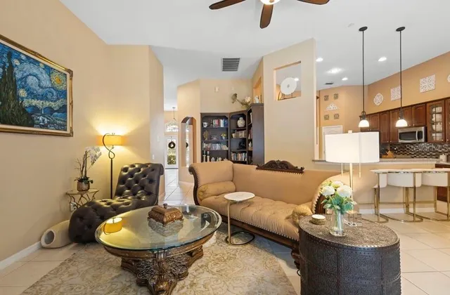 a living room with furniture and a chandelier