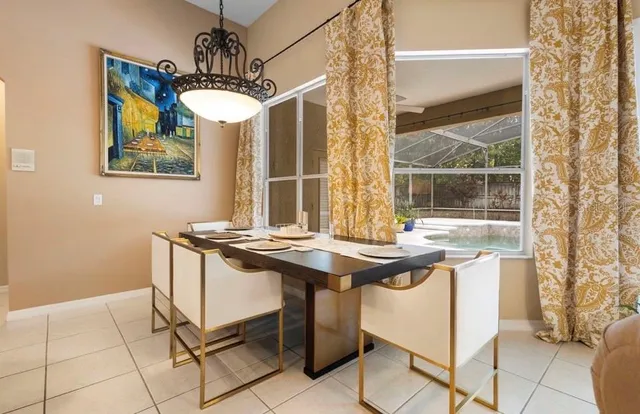 a view of a dining room with a table and chairs