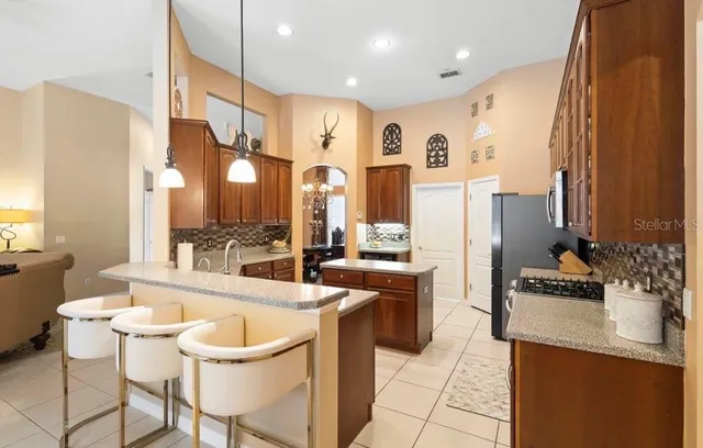 a large kitchen with a table and chairs