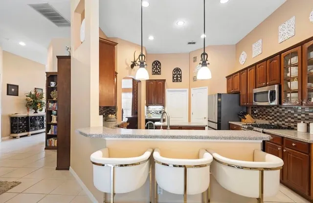 a large kitchen with a table and chairs