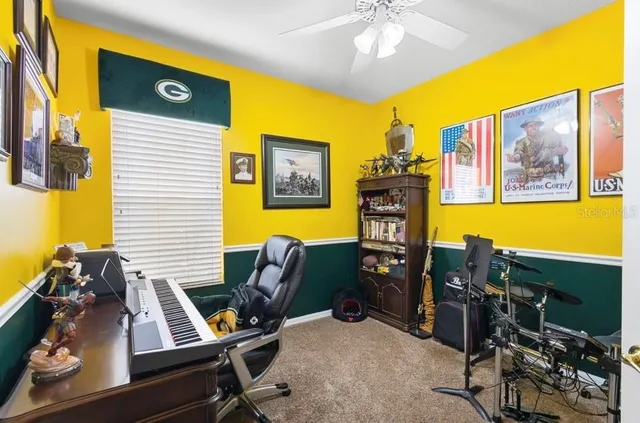 a view of a workspace with furniture and a window