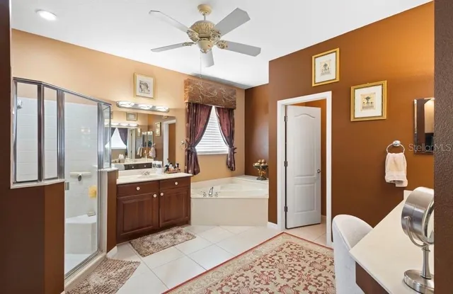 a kitchen with stainless steel appliances granite countertop a refrigerator a stove and a sink